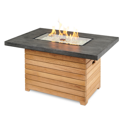 "Add contemporary flair to your outdoor oasis with the Darien Gas Fire Pit Table. Compatible with propane and natural gas, it creates a cozy ambiance. The industrial aluminum top blends seamlessly with the elegant Grade-A teak base, resulting in a distinctive aesthetic that uplifts your exterior décor."