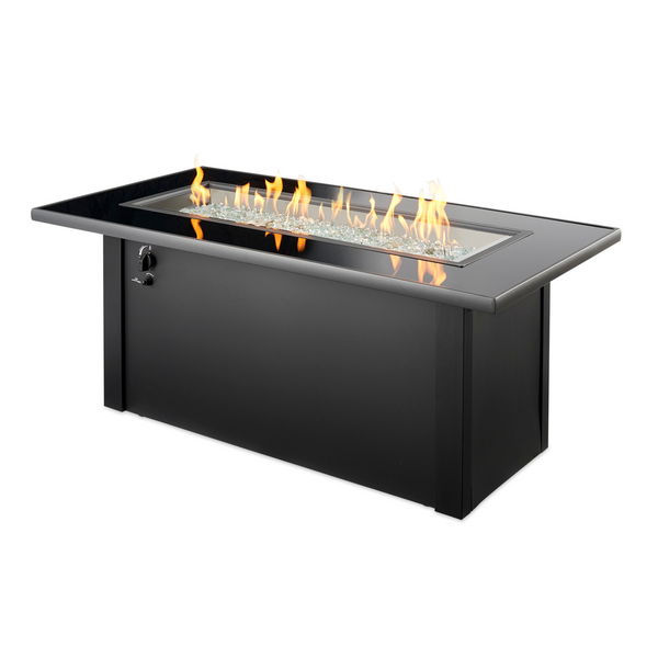 Elevate your outdoor space with the Monte Carlo Linear Gas Fire Pit Table. It features a black glass top, a durable metal base, and a 12x42 Stainless Steel Crystal Fire® Burner. Compatible with propane and natural gas, it includes an access door and a grey glass burner cover for versatility.