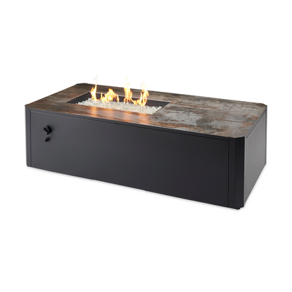 Enhance your outdoor ambiance with the Kinney Fire Pit Table. Its sleek design, low-profile base, and generous tabletop space create a modern and inviting outdoor setting. The 12" x 24" Crystal Fire® Plus Burner adds a cozy touch to your gatherings. Compatible with propane and natural gas.