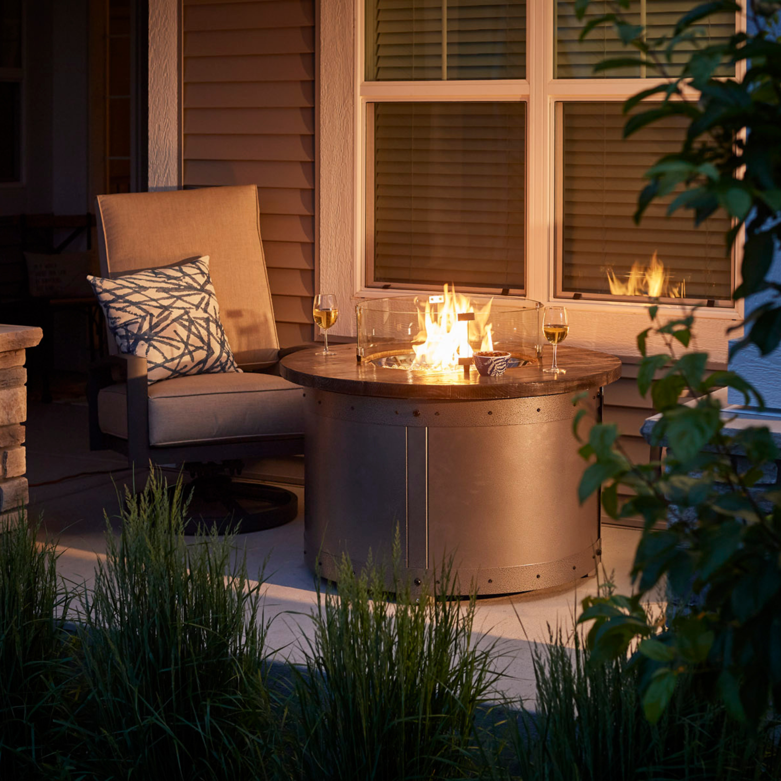 "Craft a unique outdoor space with the Edison Gas Fire Pit Table. Industrial and modern aesthetics combine in this propane and natural gas compatible table. Powder-coated steel base with a Weathered Grey Barnwood Supercast™ concrete top. Experience mesmerizing warmth and style with the UL listed Crystal Fire® Plus burner."