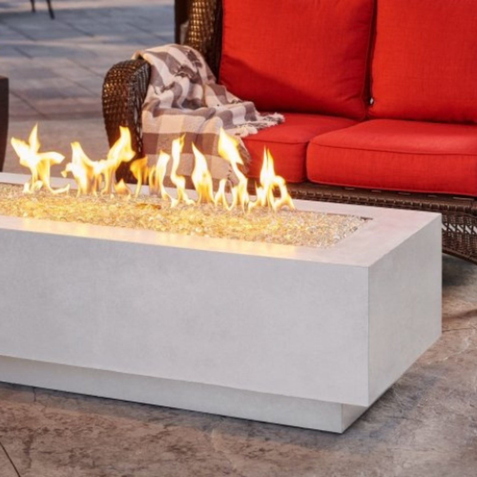 "Enhance your outdoor space with the Cove 54" Linear Gas Fire Pit Table. Propane and natural gas operation. Supercast™ concrete top in White, Midnight Mist, or Natural Grey. Unique color variations and casual pitting add character. Create a warm and inviting ambiance for relaxation and memorable moments."