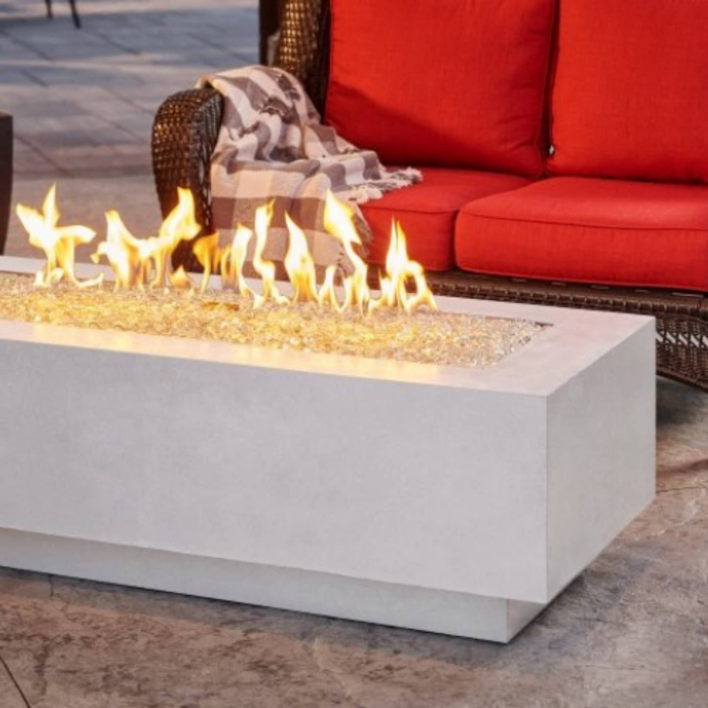 "Enhance your outdoor space with the Cove 54" Linear Gas Fire Pit Table. Propane and natural gas operation. Supercast™ concrete top in White, Midnight Mist, or Natural Grey. Unique color variations and casual pitting add character. Create a warm and inviting ambiance for relaxation and memorable moments."