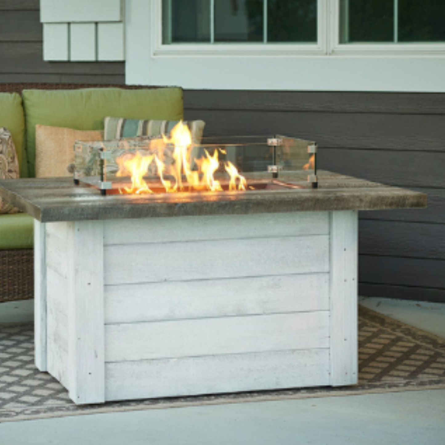 Experience warmth and elegance with the Alcott Rectangular Gas Fire Pit Table. Enhance your outdoor space with this stylish and functional centerpiece.